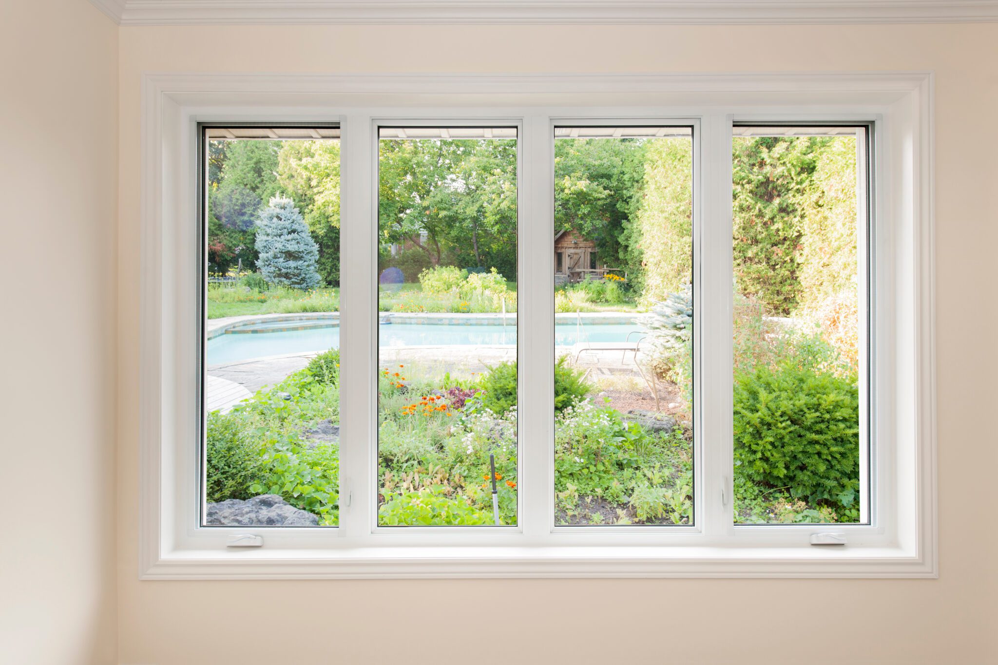 Picture windows with view of pool, landscaping, and shed