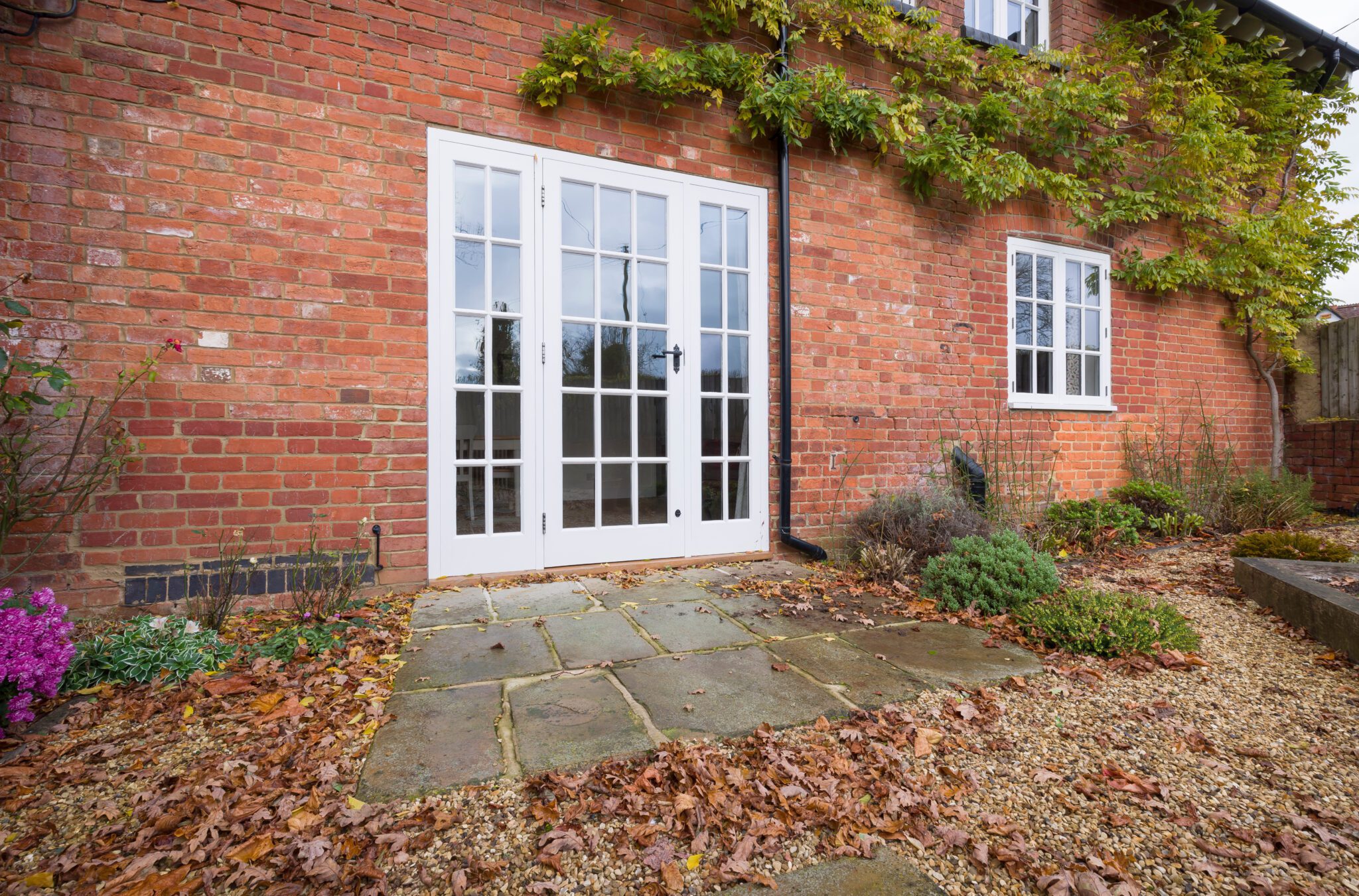 Patio door white frame on brick house